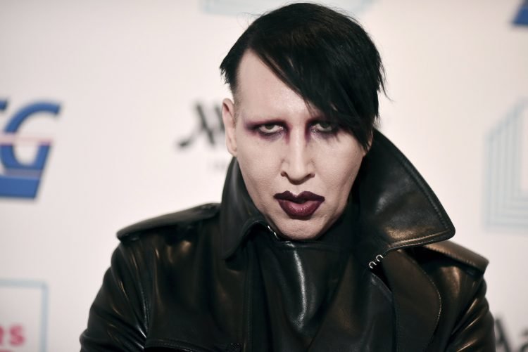 FILE - Marilyn Manson attends the 9th annual "Home for the Holidays" benefit concert on Dec. 10, 2019, in Los Angeles. Manson was dropped by his record label Monday after his ex-fiancé, the actor Evan Rachel Wood, accused him of sexual and other physical abuse. (Photo by Richard Shotwell/Invision/AP, File)